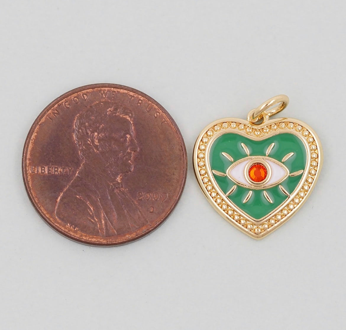 green evil eye heart charm